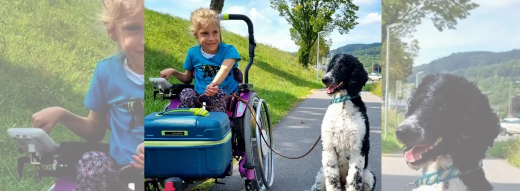 Mädchen im Rollstuhl hält Hund an der Leine.